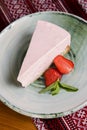 Freshly baked strawberry cheesecake with fresh strawberries and mint. Served on a plate. Royalty Free Stock Photo