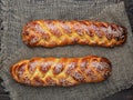 Freshly baked sweet braided bread  challah bread on a cloth, dark wooden background, top view Royalty Free Stock Photo