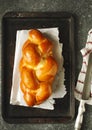 Freshly baked sweet braided bread loaf on a baking sheet. Chall Royalty Free Stock Photo