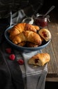 Freshly baked sweet homemade rolls filled with jam sprinkled with castor sugar, served on a rustic dark table Royalty Free Stock Photo