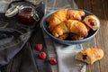 Freshly baked sweet homemade rolls filled with jam sprinkled with castor sugar, served on a rustic dark table Royalty Free Stock Photo