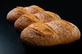 Freshly baked tasty bread on a dark table. Tasty baked goods straight from the bakery Royalty Free Stock Photo