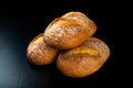 Freshly baked tasty bread on a dark table. Tasty baked goods straight from the bakery Royalty Free Stock Photo