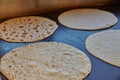 Freshly Baked Tortillas on Dark Cooking Surface in Warm Indoor Lighting Royalty Free Stock Photo