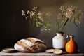 Freshly baked traditional bread on wooden table with decorative dried flowers, rustic bakery concept Royalty Free Stock Photo