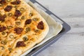 Freshly baked traditional Italian focaccia bread with green olives and sun-dried tomatoes Royalty Free Stock Photo