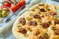 Freshly baked traditional Italian focaccia bread with green olives and sun-dried tomatoes Royalty Free Stock Photo