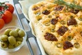 Freshly baked traditional Italian focaccia bread with green olives and sun-dried tomatoes Royalty Free Stock Photo