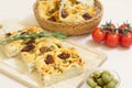 Freshly baked traditional Italian focaccia bread with green olives and sun-dried tomatoes Royalty Free Stock Photo
