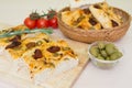 Freshly baked traditional Italian focaccia bread with green olives and sun-dried tomatoes Royalty Free Stock Photo