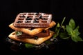 Freshly baked Viennese waffles on a black table