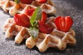 Freshly baked waffles with strawberries close-up on the slate. h Royalty Free Stock Photo