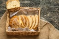 Freshly baked wheat bread on natural linen napkin and bag. Homemade bakery. Still life of bread. Slice of gold rustic crusty loave