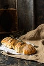 Freshly baked wheat bread on natural linen napkin and bag. Homemade bakery. Still life of bread. Slice of gold rustic crusty loave