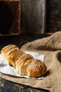 Freshly baked wheat bread on natural linen napkin and bag. Homemade bakery. Still life of bread. Slice of gold rustic crusty loave