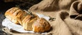 Freshly baked wheat bread on natural linen napkin and bag. Homemade bakery. Still life of bread. Slice of gold rustic crusty loave