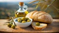 Freshly baked white bread, with olive oil and green olives, on a wooden board. Mediterranean food.