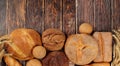 Freshly baked whole grain homemade bread, assorted varieties of round sourdough bread with crispy crust and ears of rye and wheat Royalty Free Stock Photo