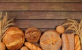 Freshly baked whole grain homemade bread, assorted varieties of round sourdough bread with crispy crust and ears of rye and wheat Royalty Free Stock Photo