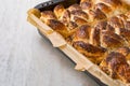 Freshly baked wicker buns with poppy seeds in a baking dish. Bakery products, pastries, baked buns lie on the table.