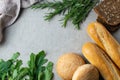 Freshly bakes bread, herbs and greens on a table, overhead flat lay Royalty Free Stock Photo