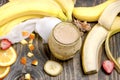 Freshly blended banana shake - bananna smoothie, healthy cold refreshing beverage drink on table Royalty Free Stock Photo