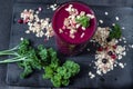 Freshly blended berry smoothie in a glass and granola on dark rustic wooden background. Selective focus, copy space Royalty Free Stock Photo