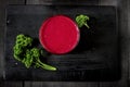 Freshly blended berry smoothie in a glass and granola on dark rustic wooden background. Selective focus, copy space Royalty Free Stock Photo