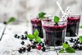 Freshly blended berry smoothies with assorted currants and mint leaves on wooden table Royalty Free Stock Photo