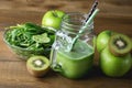 Freshly Blended Green Fruit Smoothie in Glass Jar with Straw. Spinach Aragula Green Apple Kiwi Detox Healthy Food Toned