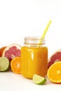 Freshly blended yellow and orange fruit smoothie in glass jar. Glass jar mugs with orange health smoothie, lime, grapefruit, lemon Royalty Free Stock Photo