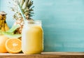 Freshly blended yellow and orange fruit smoothie in glass jar with straw Royalty Free Stock Photo