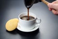 Freshly brewed black coffee from the turks poured in a white Cup Royalty Free Stock Photo