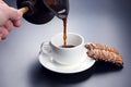 Freshly brewed black coffee from the turks poured in a white Cup Royalty Free Stock Photo