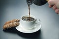 Freshly brewed black coffee from the turks poured in a white Cup Royalty Free Stock Photo