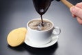 Freshly brewed black coffee from the turks poured in a white cup Royalty Free Stock Photo
