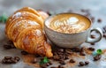 Freshly brewed cappuccino coffee and croissant on gray table Royalty Free Stock Photo