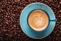 Freshly brewed coffee crema in a cup on coffee beans bedded Royalty Free Stock Photo