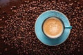 Freshly brewed coffee crema in a cup on coffee beans bedded Royalty Free Stock Photo