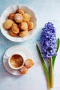 Freshly brewed espresso, small homemade doughnuts with icing sugar