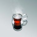 Freshly brewed hot black tea in double sided modern transparent glass mug.