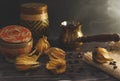 Freshly brewed hot coffee with steam in traditional turkish cezve. Physalis and coffee beans lie on the wooden vintage table. Royalty Free Stock Photo