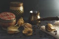 Freshly brewed hot coffee with steam in traditional turkish cezve. Physalis and coffee beans lie on the wooden vintage table. Royalty Free Stock Photo