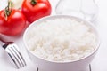 Freshly brewed rice and tomatoes on a wooden table