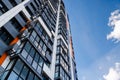 freshly built high rise apartment building on blue sky background with white clouds Royalty Free Stock Photo