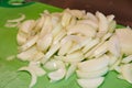 Freshly Chopped Onions on Bright Green Cutting Board Close-Up Royalty Free Stock Photo