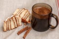 Freshly cinnabon French bun with cinnamon and coffee, selective focus Royalty Free Stock Photo