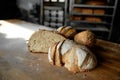 Freshly cooked artisan bread half and sliced on table bakery shop