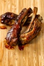 Freshly cooked BBQ ribs with sauce on wooden board Royalty Free Stock Photo
