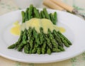 Freshly cooked green asparagus with hollandaise sauce Royalty Free Stock Photo